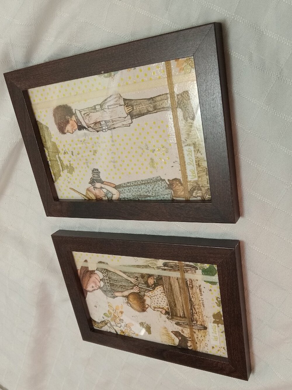A set of delicate picture frames for a baby's room with vintage wrapping paper
